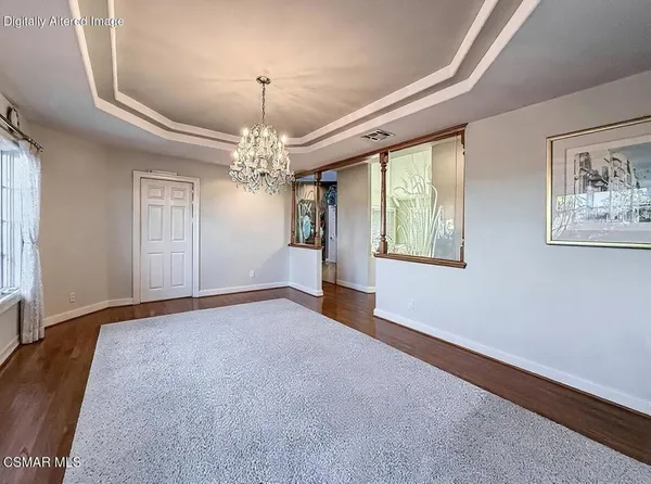 a view of a patio with a table and chairs under an umbrella