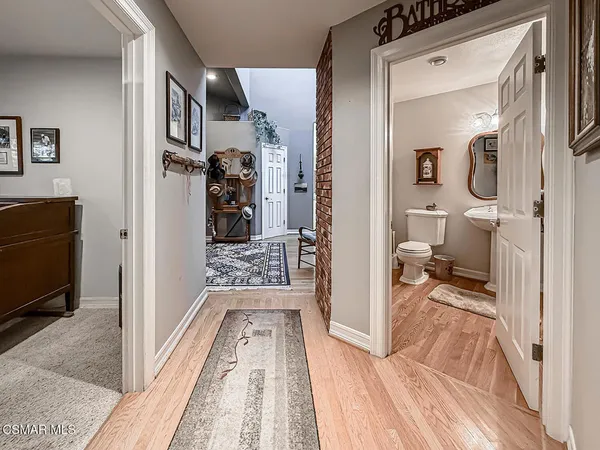 a view of a balcony with table and chairs and wooden floor