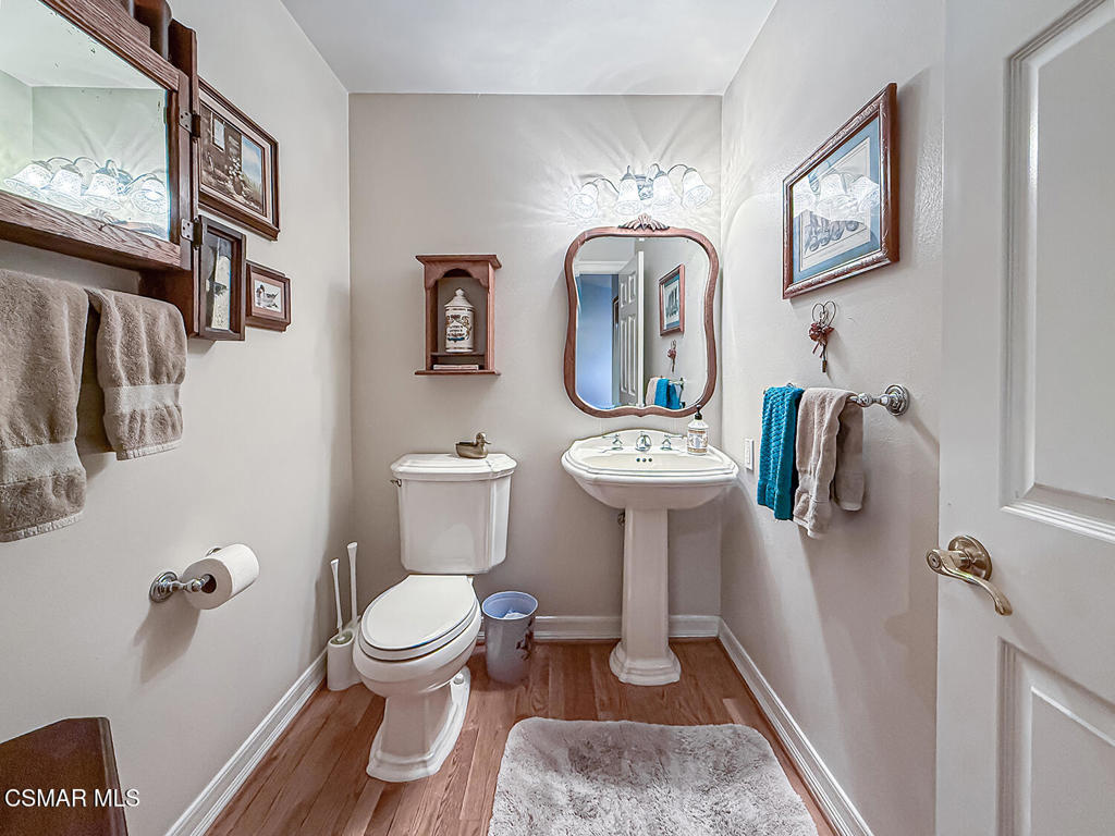 24525 Desert Avenue Newhall, CA 91321 - Photo 16 of 76 a bathroom with a toilet sink and mirror