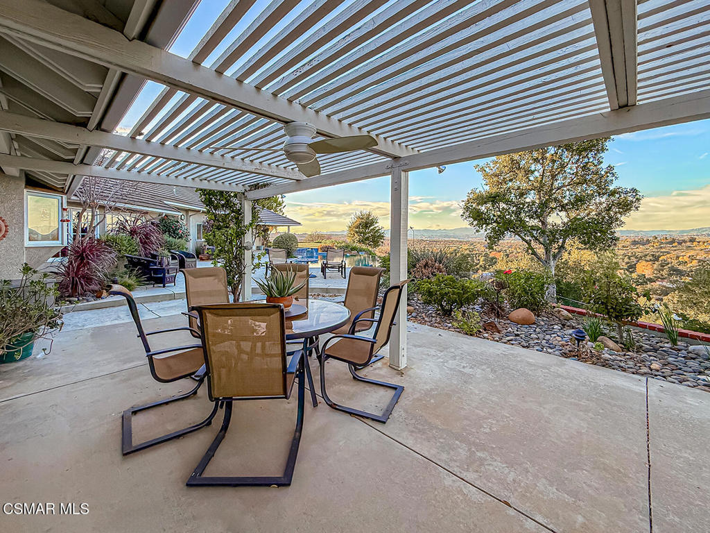 24525 Desert Avenue Newhall, CA 91321 - Photo 23 of 76 a view of a patio with table and chairs and potted plants