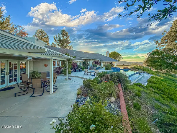 a hallway with painting on the wall and a shower