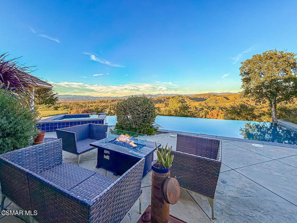 24525 Desert Avenue Newhall, CA 91321 - Photo 27 of 76 a view of a balcony with table and chairs and wooden floor