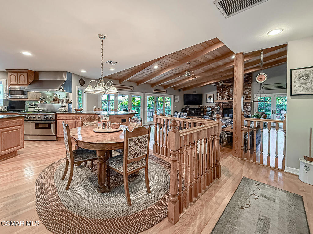 24525 Desert Avenue Newhall, CA 91321 - Photo 29 of 76 a dining room with furniture a rug and kitchen view