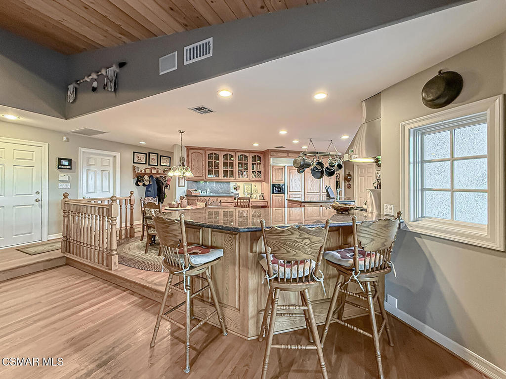 24525 Desert Avenue Newhall, CA 91321 - Photo 30 of 76 a view of a dining room with furniture and wooden floor