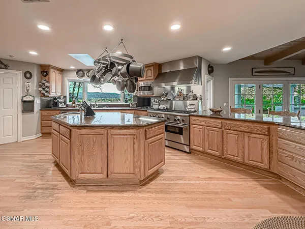 a living room with furniture ceiling fan and a window