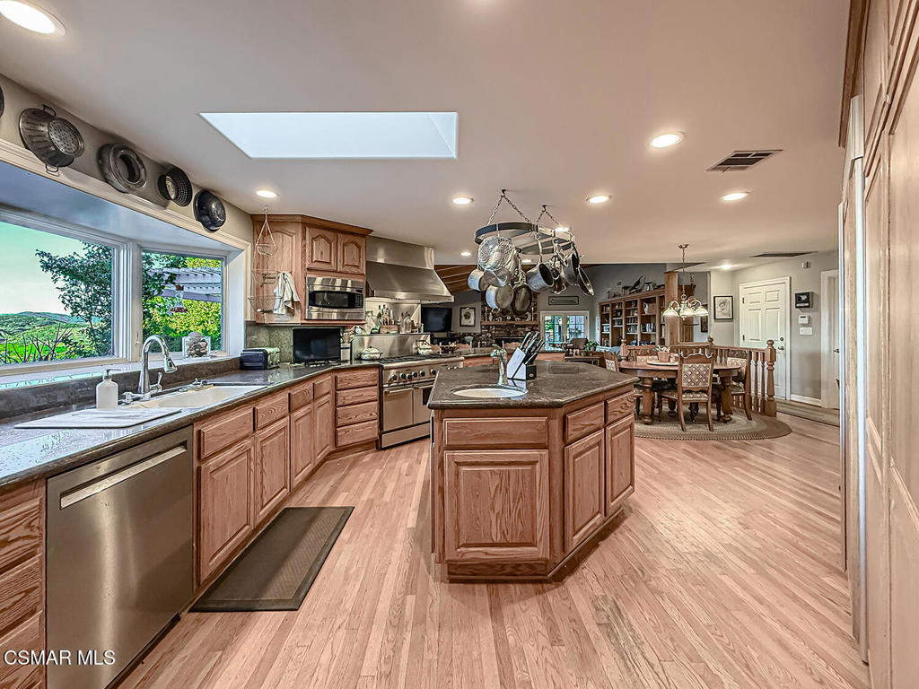 24525 Desert Avenue Newhall, CA 91321 - Photo 38 of 76 a large kitchen with stainless steel appliances lots of counter space and a sink
