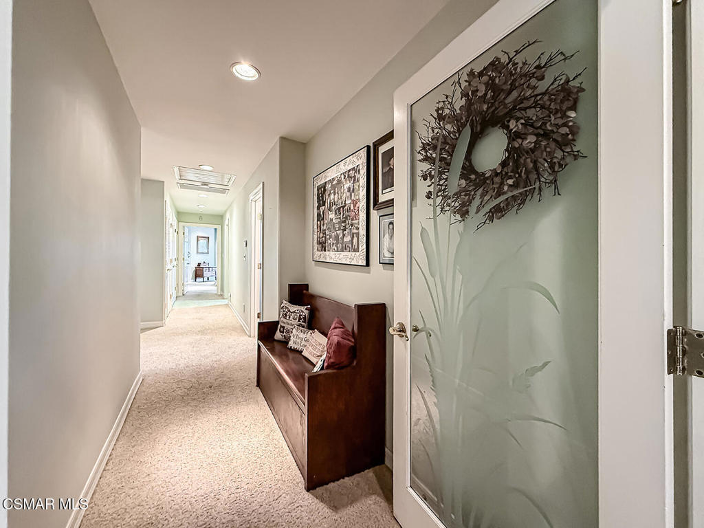 24525 Desert Avenue Newhall, CA 91321 - Photo 39 of 76 a hallway with painting on the wall and a shower