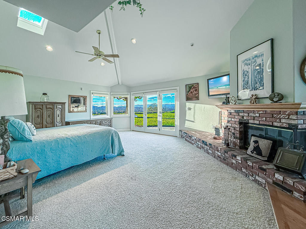 24525 Desert Avenue Newhall, CA 91321 - Photo 54 of 76 a bedroom with a bed and a fireplace