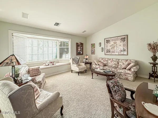 a bedroom with a large bed and a desk