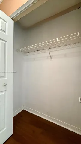a bathroom with a granite countertop sink a toilet and a large mirror
