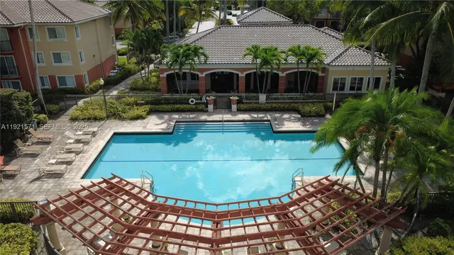 a view of a house with swimming pool and furniture