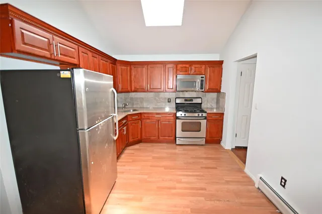 a kitchen with stainless steel appliances a refrigerator and a stove