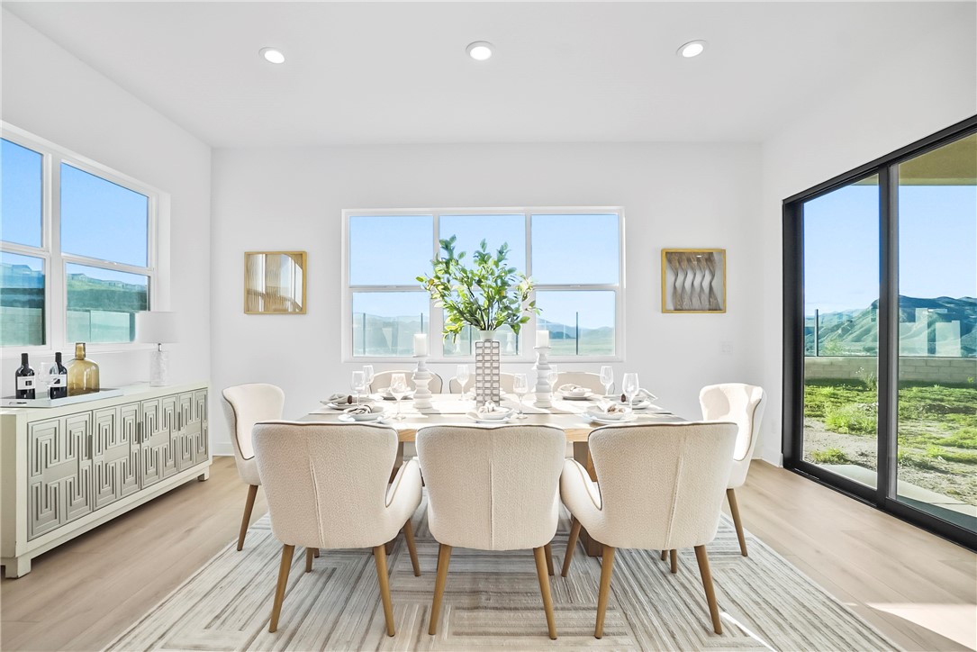 27392 Dialogue Way Valencia, CA 91381 - Photo 15 of 62 a dining room with furniture a large window and wooden floor