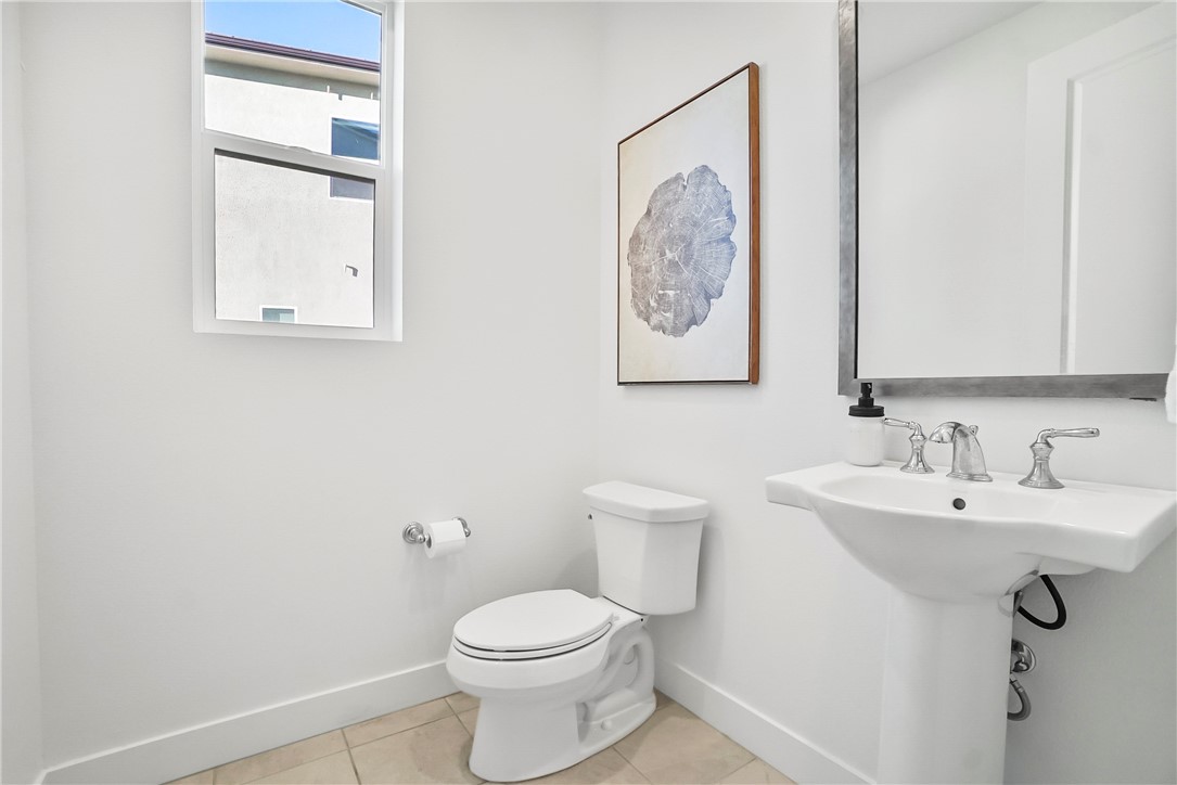 27392 Dialogue Way Valencia, CA 91381 - Photo 18 of 62 a bathroom with a toilet sink and mirror