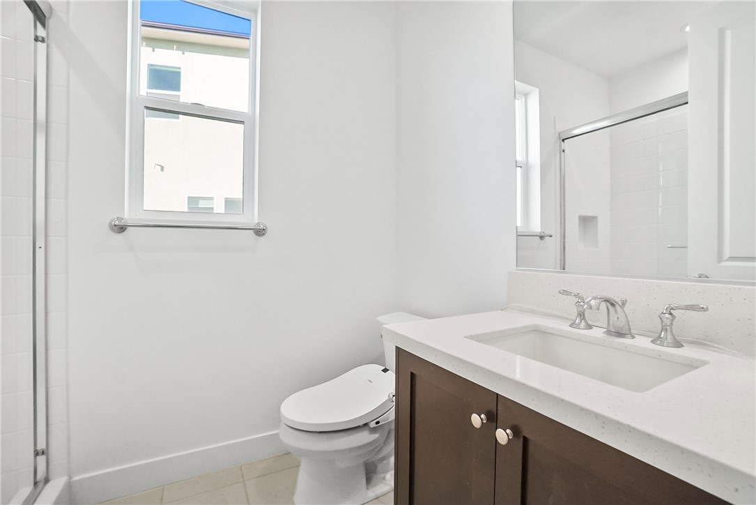 27392 Dialogue Way Valencia, CA 91381 - Photo 20 of 62 a bathroom with a sink a toilet and a window