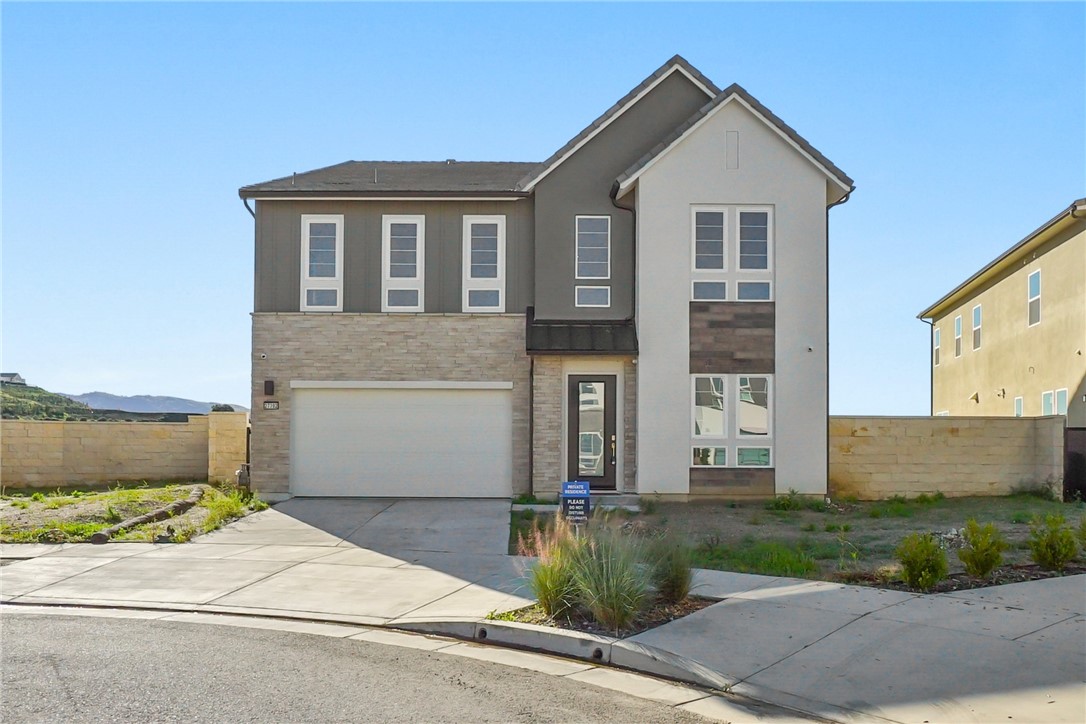 27392 Dialogue Way Valencia, CA 91381 - Photo 2 of 62 a front view of a house with a yard and garage