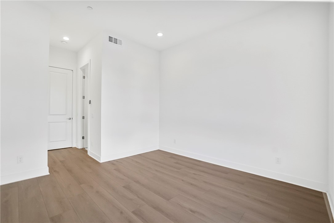 27392 Dialogue Way Valencia, CA 91381 - Photo 21 of 62 a view of wooden floor in an empty room