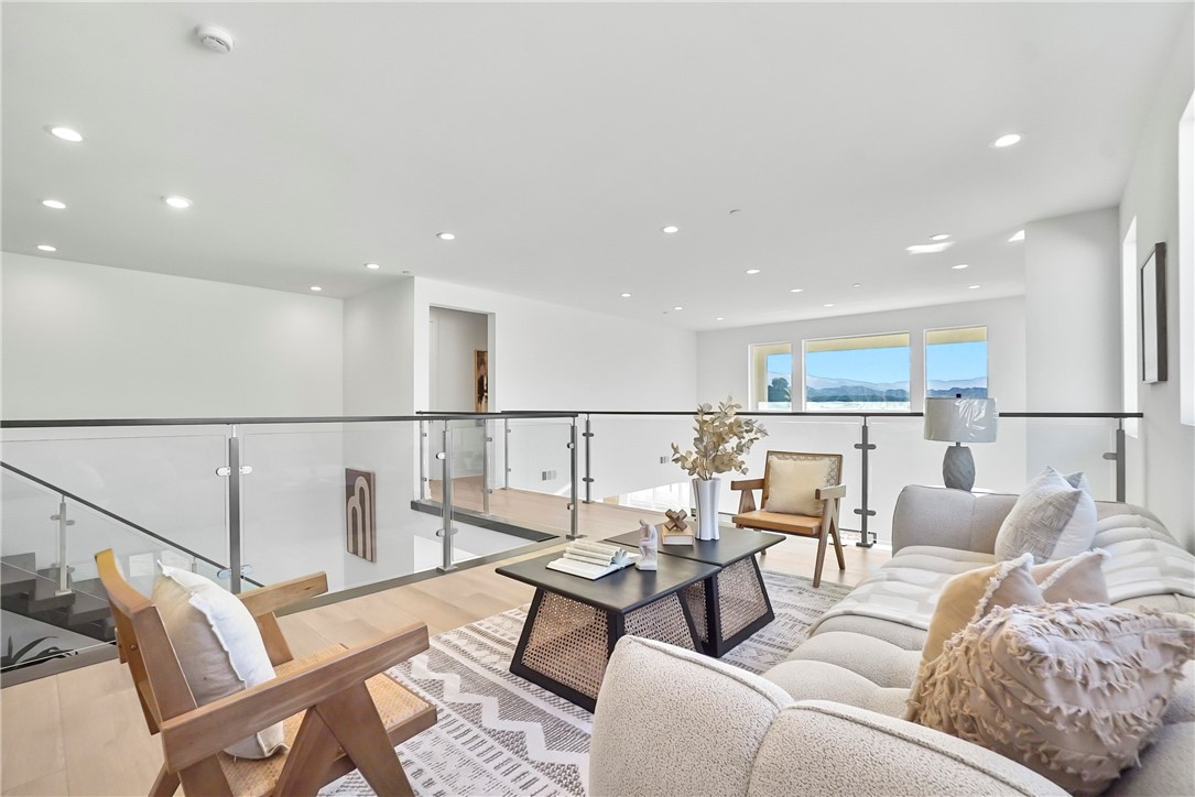 27392 Dialogue Way Valencia, CA 91381 - Photo 22 of 62 a living room with furniture wooden floor and a view of kitchen