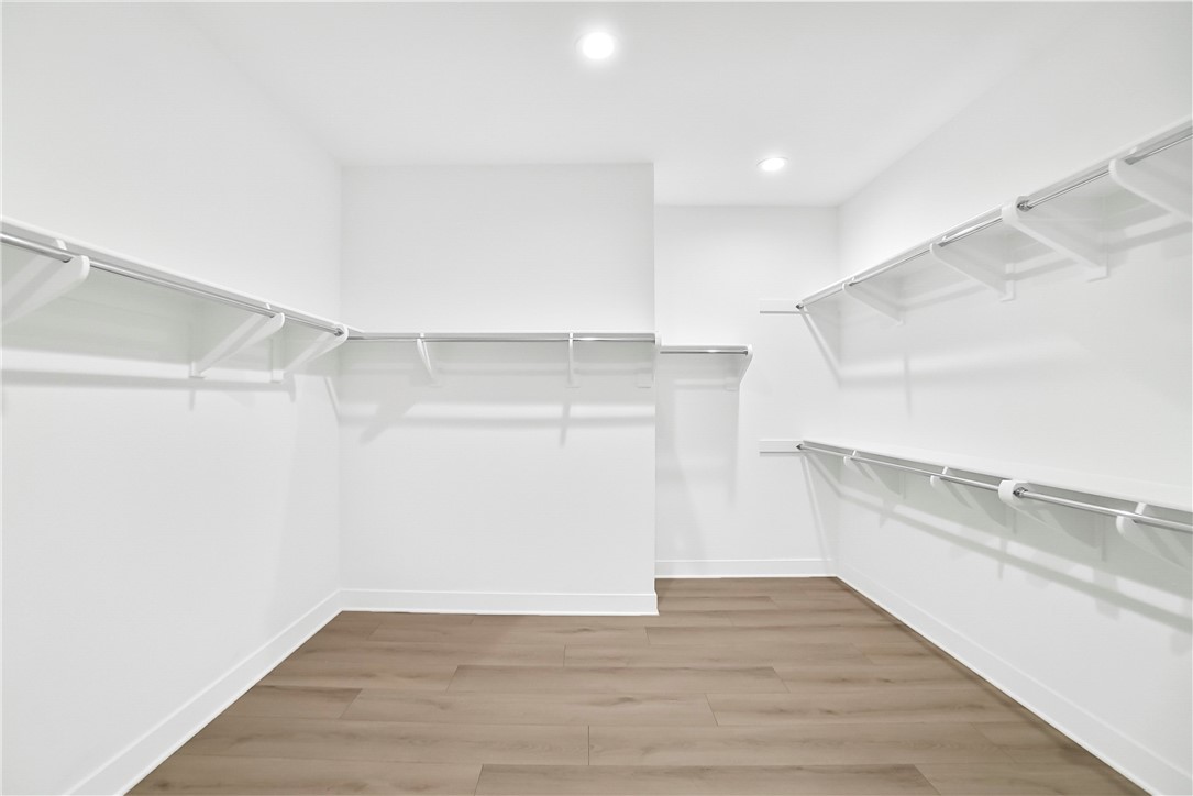 27392 Dialogue Way Valencia, CA 91381 - Photo 31 of 62 a view of an empty room with wooden floor