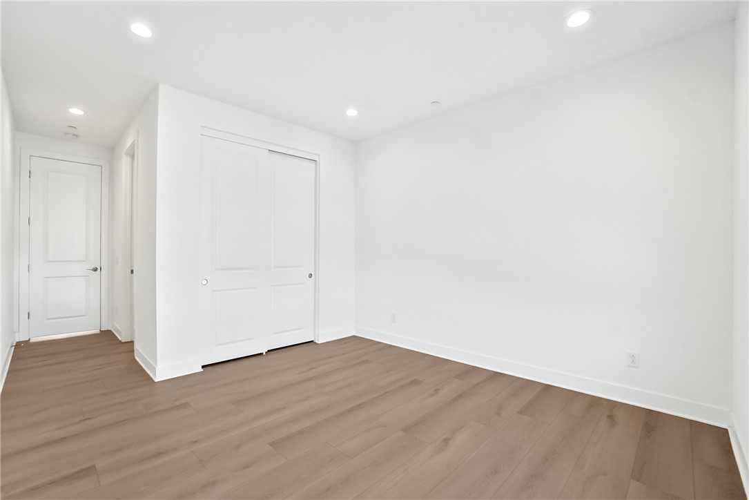 27392 Dialogue Way Valencia, CA 91381 - Photo 35 of 62 an empty room with wooden floor