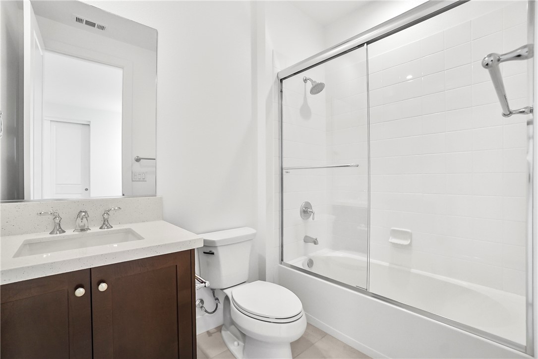 27392 Dialogue Way Valencia, CA 91381 - Photo 37 of 62 a bathroom with a sink a toilet and a mirror