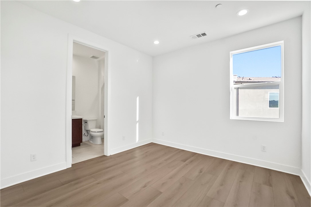 27392 Dialogue Way Valencia, CA 91381 - Photo 38 of 62 an empty room with wooden floor and windows
