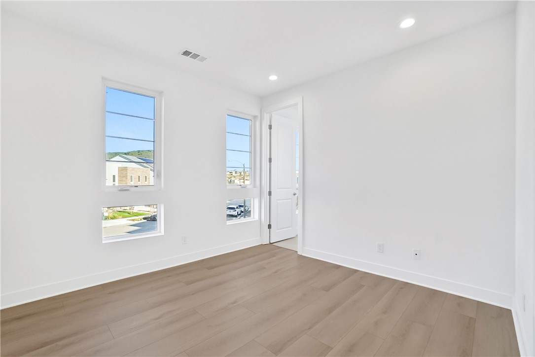 27392 Dialogue Way Valencia, CA 91381 - Photo 39 of 62 wooden floor in an empty room with a window