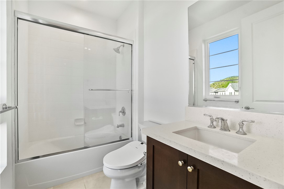 27392 Dialogue Way Valencia, CA 91381 - Photo 42 of 62 a bathroom with a granite countertop sink toilet and shower