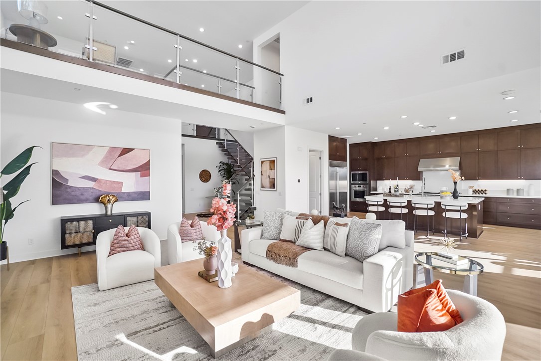27392 Dialogue Way Valencia, CA 91381 - Photo 9 of 62 a living room with furniture and kitchen view