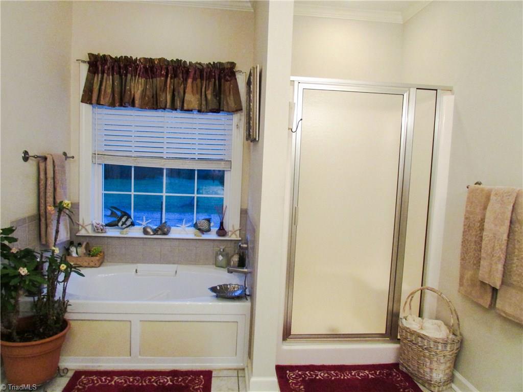 2791 Beckerdite Road Sophia, NC 27350 - Photo 21 of 25 Master Bath Features A Jetted Garden Tub With Picture Window With Shelf Sill, Separate Shower, Toilet Room, Big Walk-In Closet, Solid Surface Double Sink Counters, Recessed & Vanity Lighting Tile + Crown Moulding.