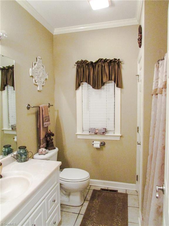 2791 Beckerdite Road Sophia, NC 27350 - Photo 24 of 25 2nd Bath Features Tile, Solid Surface Marble Counter-Tops, Linen Closet, Shower/Tub Combo + Crown Moulding