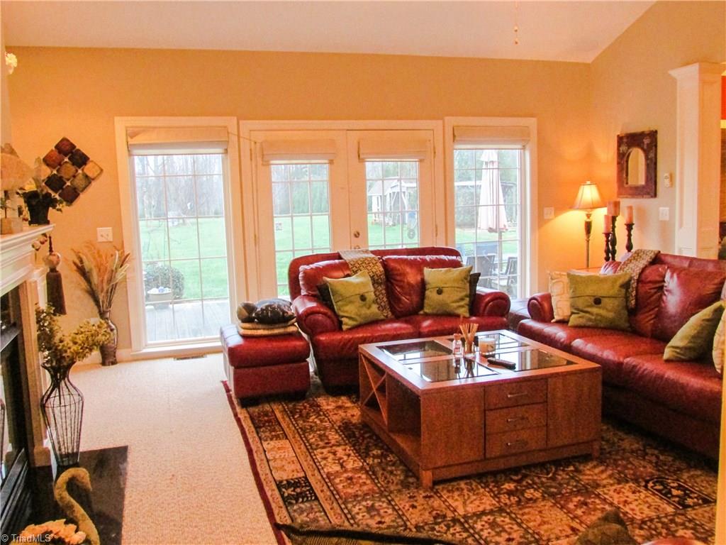2791 Beckerdite Road Sophia, NC 27350 - Photo 8 of 25 This Big Living Room Features Plenty of Natural Light, French Doors, Gas Log Fireplace, Tall Cathedral Ceiling w/Ceiling Fan, Berber Carpeting and Built-In Adjustable Bookshelves & Cabinetry,