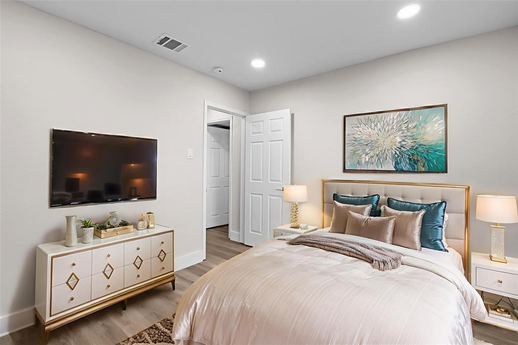 2008 East Peters Colony Road Carrollton, TX 75007 - Photo 16 of 35 a bedroom with a bed and a flat screen tv