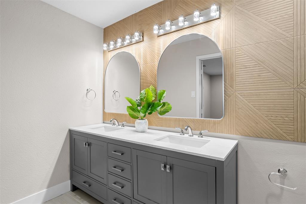 2008 East Peters Colony Road Carrollton, TX 75007 - Photo 19 of 35 a bathroom with a double vanity sink and a mirror