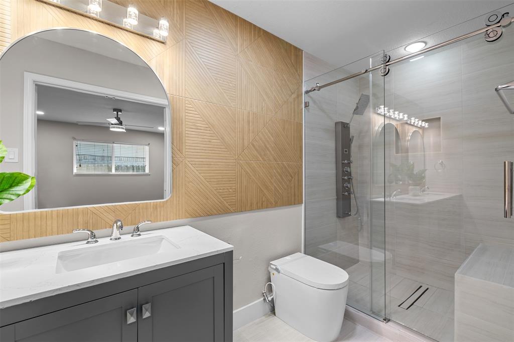 2008 East Peters Colony Road Carrollton, TX 75007 - Photo 20 of 35 a bathroom with a sink toilet and shower