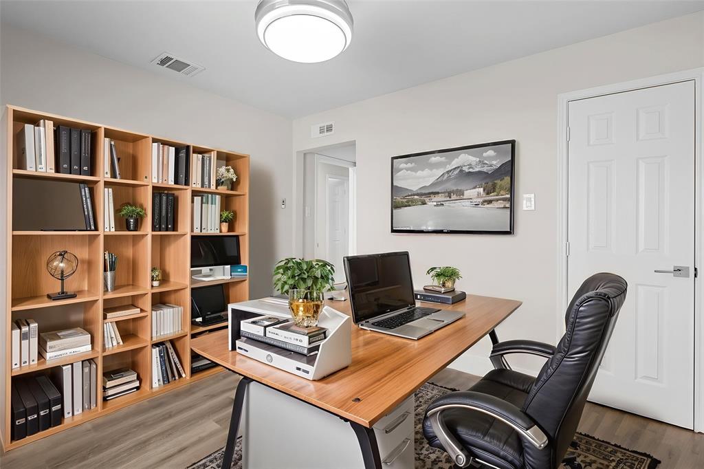 2008 East Peters Colony Road Carrollton, TX 75007 - Photo 22 of 35 a view of a workspace with furniture and bookshelf