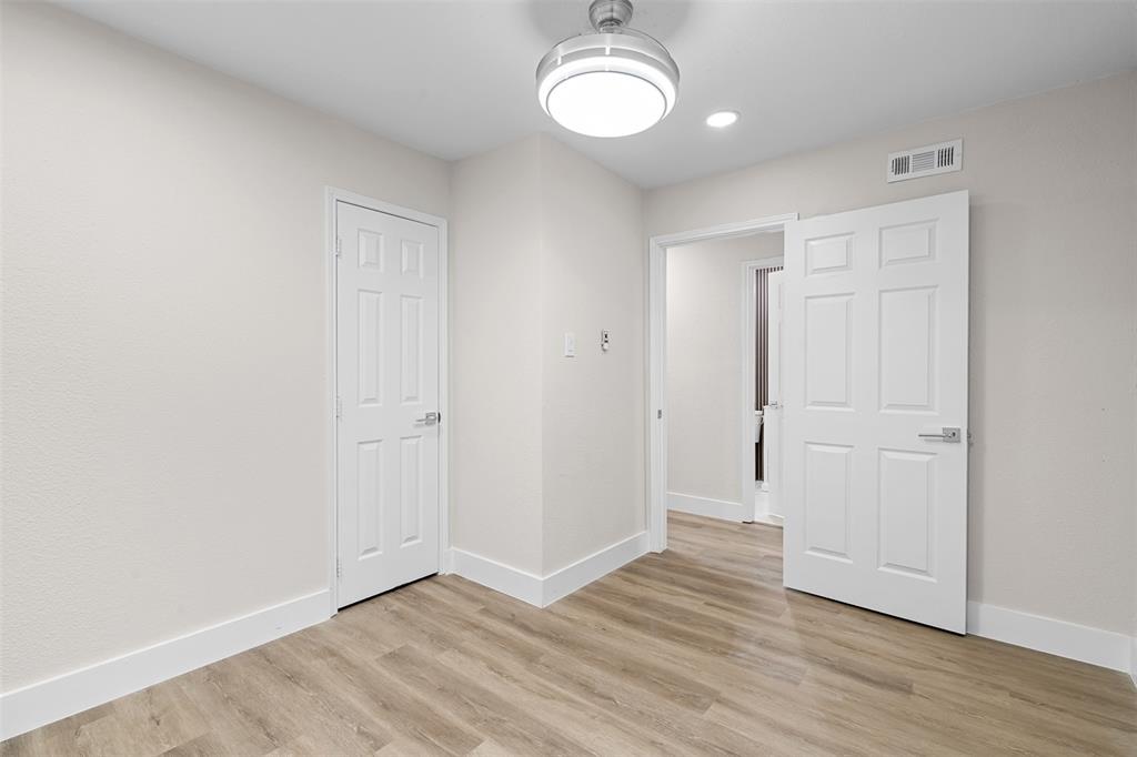 2008 East Peters Colony Road Carrollton, TX 75007 - Photo 23 of 35 a view of an empty room with wooden floor