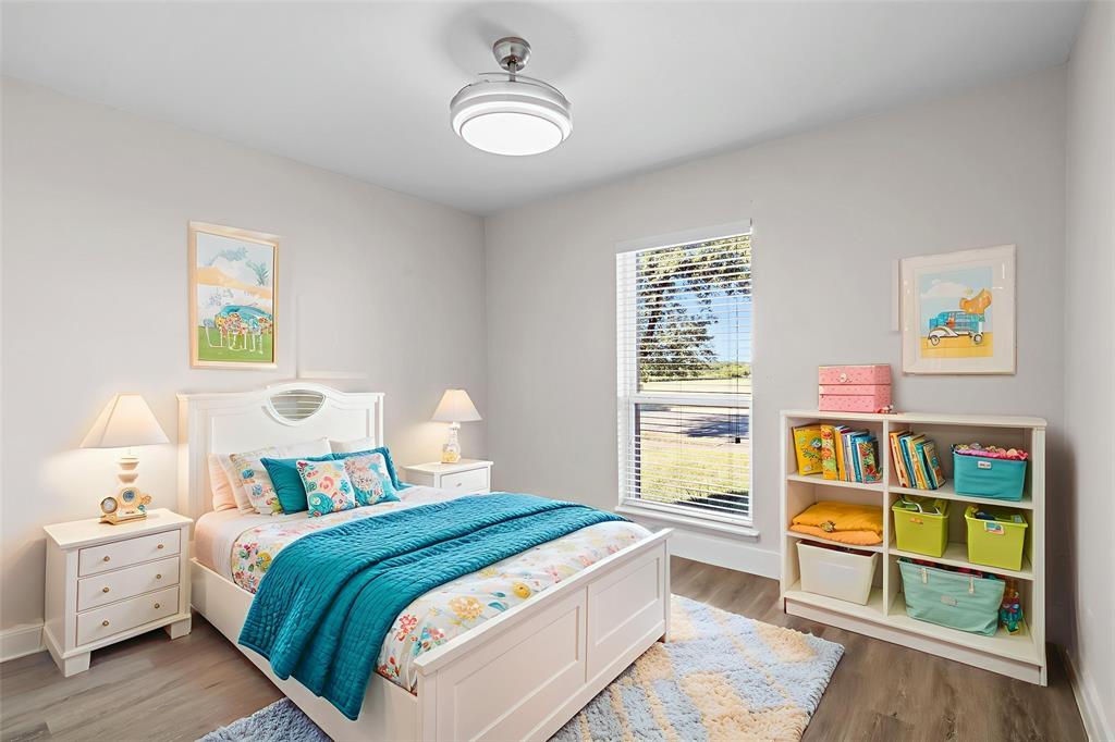 2008 East Peters Colony Road Carrollton, TX 75007 - Photo 24 of 35 a bedroom with a bed and wooden floor