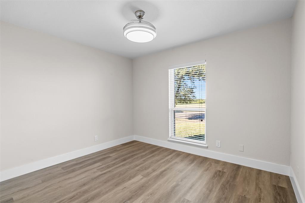 2008 East Peters Colony Road Carrollton, TX 75007 - Photo 25 of 35 wooden floor in an empty room with a window