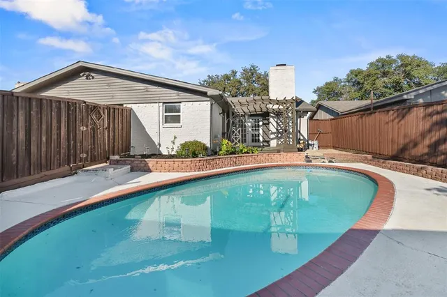a view of a swimming pool with a backyard