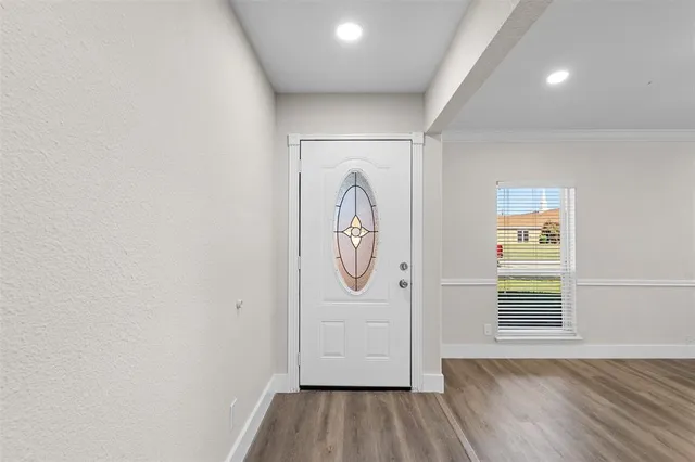 a living room with furniture a flat screen tv and a chandelier