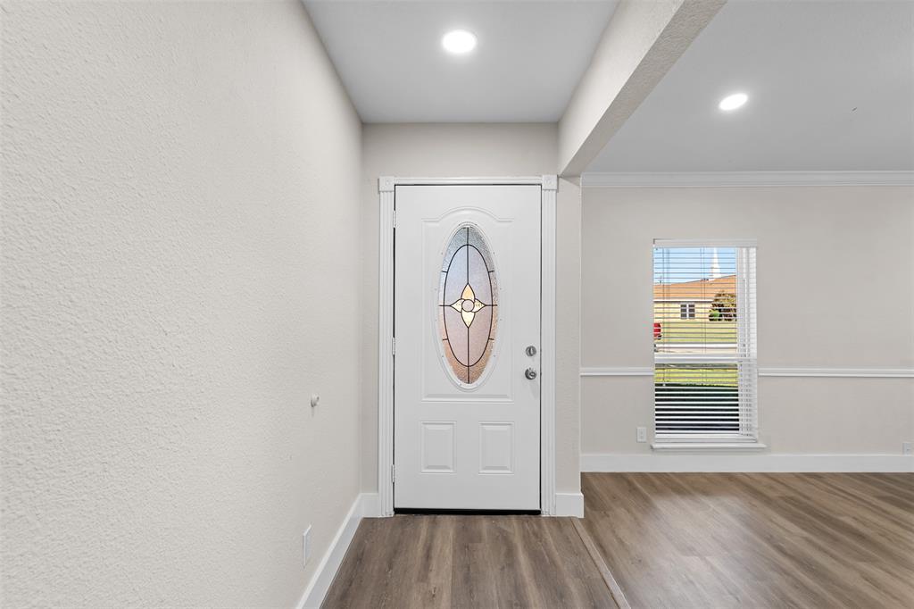 2008 East Peters Colony Road Carrollton, TX 75007 - Photo 4 of 35 a view of a livingroom with wooden floor and a window