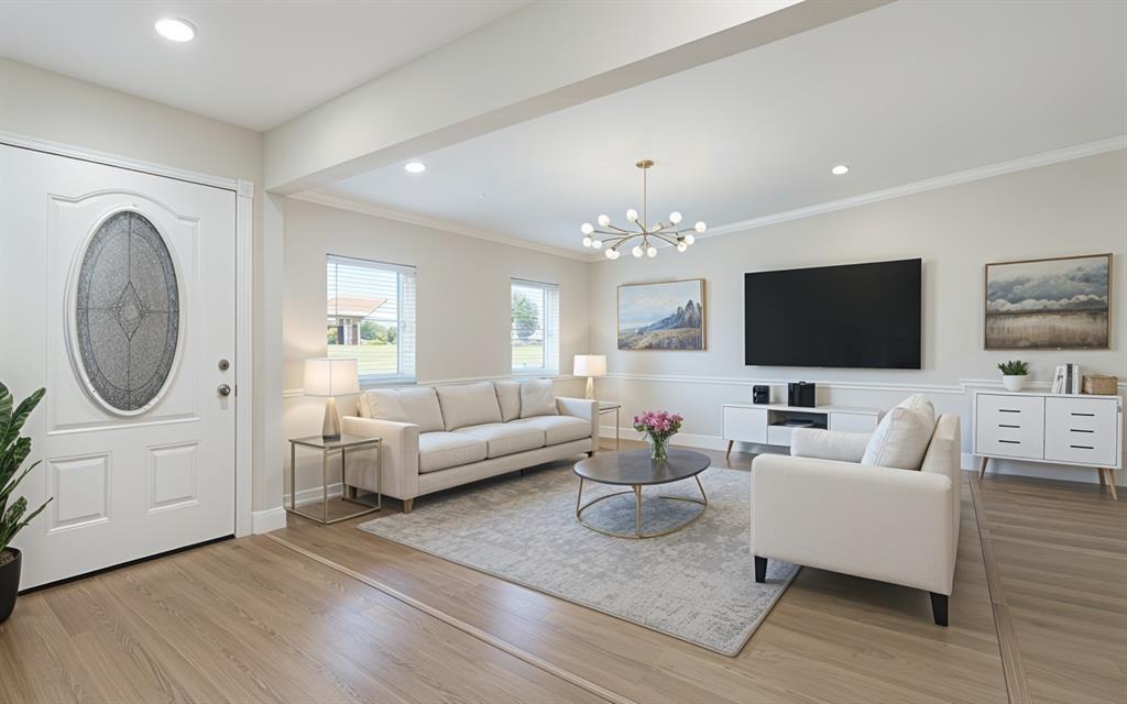 2008 East Peters Colony Road Carrollton, TX 75007 - Photo 5 of 35 a living room with furniture a flat screen tv and a chandelier