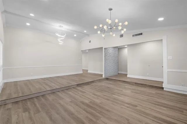 a view of a dining room with furniture wooden floor and chandelier