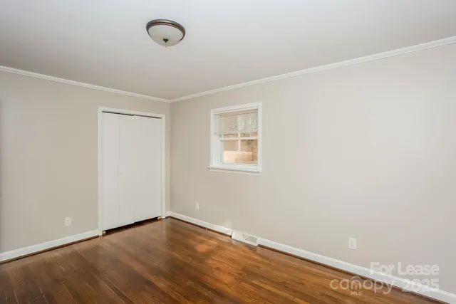 a view of a room with wooden floor and fan
