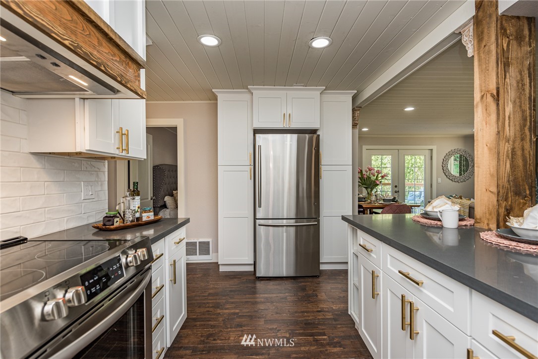 1391 Atterberry Road Sequim, WA 98382 - Photo 5 of 36 a kitchen with a stove and a refrigerator