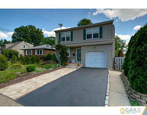 20 Kimberly Road Colonia, NJ 07067 - Photo 1 of 25 a front view of a house with a yard and garage