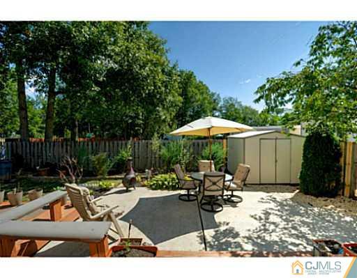 20 Kimberly Road Colonia, NJ 07067 - Photo 22 of 25 a backyard of a house with table and chairs