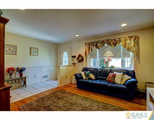 20 Kimberly Road Colonia, NJ 07067 - Photo 4 of 25 a living room with furniture and a flat screen tv