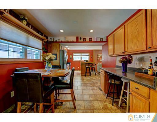 20 Kimberly Road Colonia, NJ 07067 - Photo 6 of 25 a dining hall with stainless steel appliances a dining table and chairs